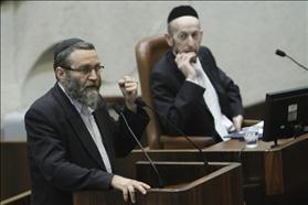 Chairman of the finance committee, Moshe Gafni from Degel Ha'tora, raising his fist during a speech at the Knesset assembly. To his right his party member Uri Maklev.07.05.2012. Photographed by: Miriam Elster, Flash 90.   