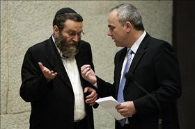 Finance Minister, Yuval Steinitz of Likud in a  conversation with chairman of the Knesset's Financial Committee, Moshe Gafni of Degel Hatorah during voting on the Arrangements Law.15.07.2009. Photo: Abir Sultan, Flash 90