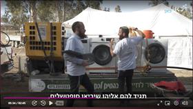 Volunteers drive between army bases with washing  machines on a truck, to wash soldier's laundry