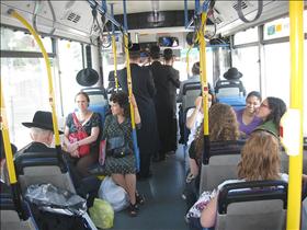 Women's organizations activists sitting in the front of  the segregated buses. 30.09.2009. Photography: Shiran Dadon 