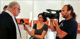 Rabbi Uri Regev being interviewed by reporters following Supreme Court hearing on permitting non-Orthodox military burials in Israel (July 4, 2019)