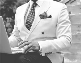 Man in tuxedo with laptop