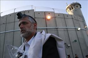 Chairman of Shas and Minister of Internal Affairs,Eli Yishai, laying phylacteries at Rachel's Tomb on the traditional day of visiting her grave. Photograph by: Uri Lenz, Flash 90.